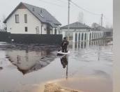 Пскович перемещается по затопленным улицам на сапборде